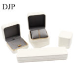 White leather jewelry box set with gray microfiber interior for rings, necklaces, and bracelets – custom packaging from China.