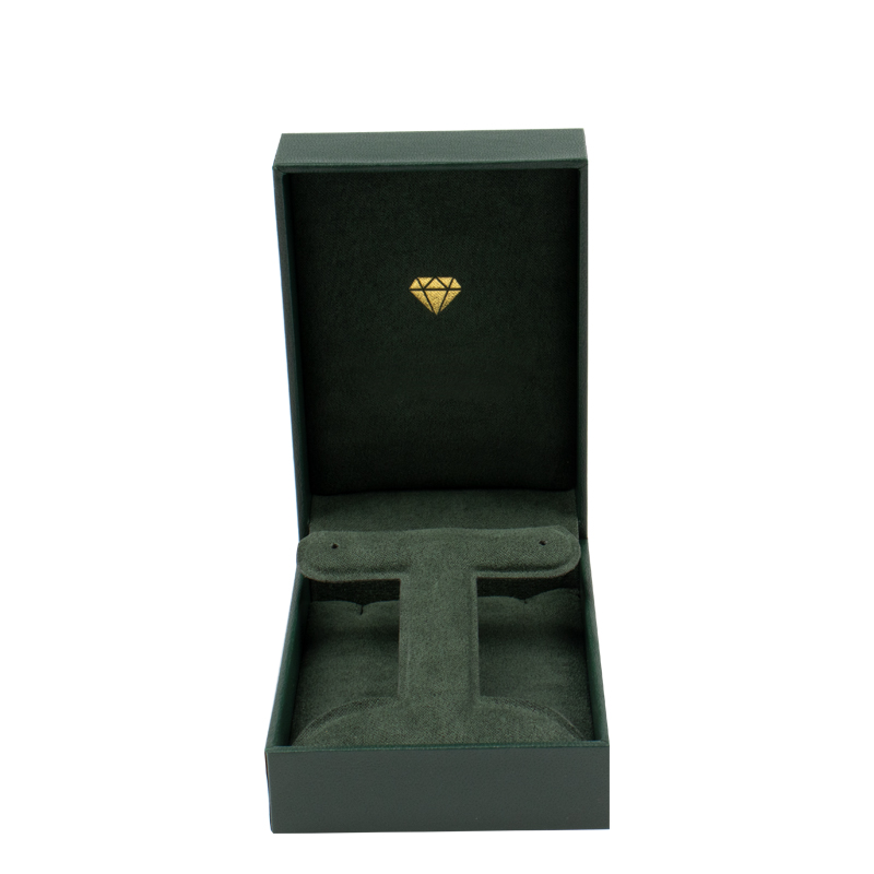 Green Rectangular Jewelry Box with Foldable Insert Green leatherette rectangular jewelry box with a foldable microfiber insert for earrings and a pendant.