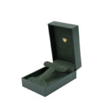 Green leatherette rectangular jewelry box with a foldable microfiber insert for earrings and a pendant.