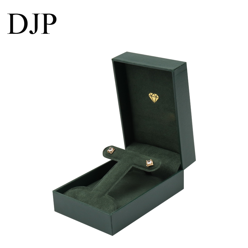 Green Rectangular Jewelry Box with foldable Insert Green leatherette rectangular jewelry box with a foldable microfiber insert for earrings and a pendant.